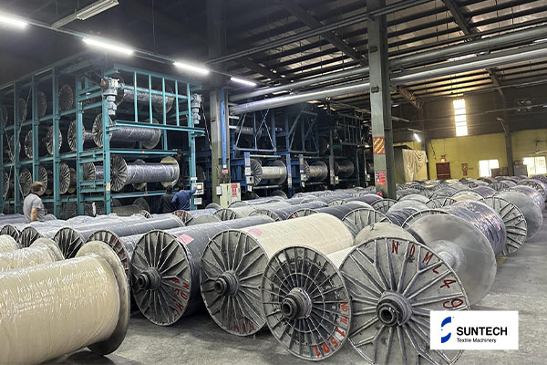 Solución de almacenamiento de haz de urdimbre de alta densidad: utilización de espacio máximo en la fábrica textil
